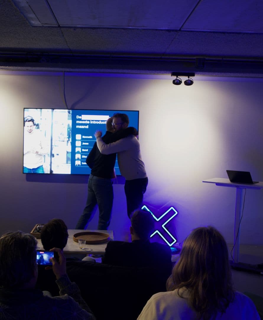 Collega's vieren samen een succes onder het Search X-neonlogo